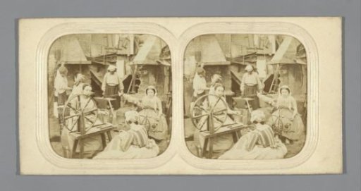 Scene in workshop: two men at forge, three women at spinning wheel