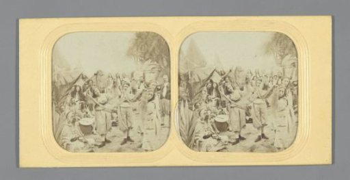 Oriental scene in photography studio: dancing women, men with musical instruments