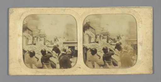 Firemen on a roof with onlookers