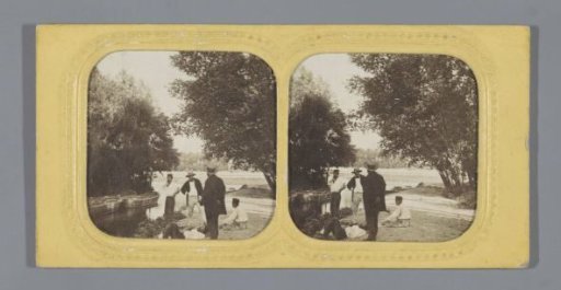 Five men on a bank near several boats