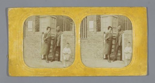 Married couple with a child in front of a house