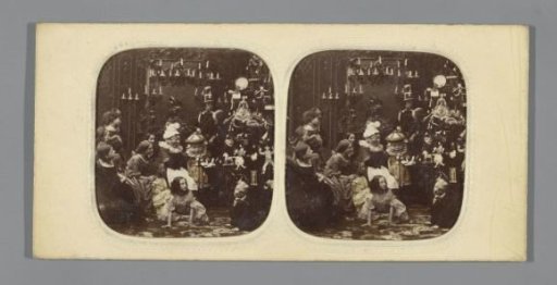 Children around a Christmas tree with dolls