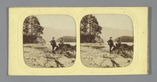 Two boys on the shore of a mountain lake