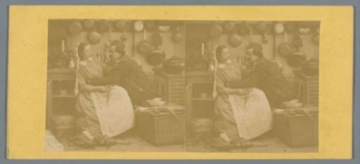 Woman trying to push a man away in a kitchen