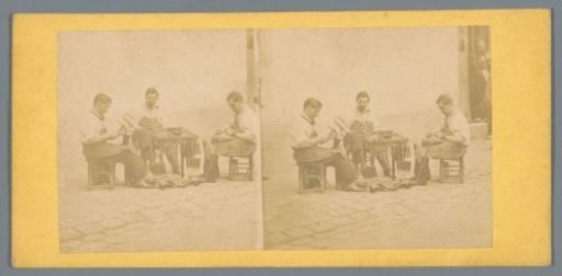Three shoemakers at work on the street