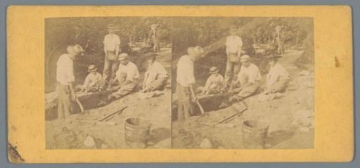 Men and boys digging in a garden