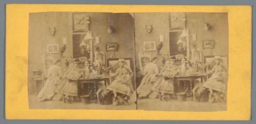 Company around a table and a woman behind an easel in a room decorated with stuffed animals