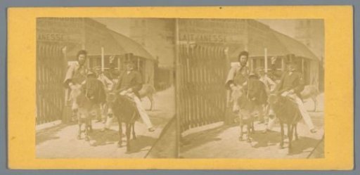 Man with a tall hat and a woman riding on donkeys
