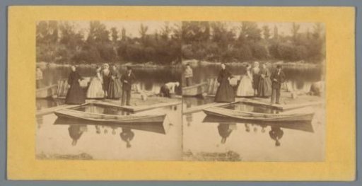 Company on a jetty with rowing boats in the water