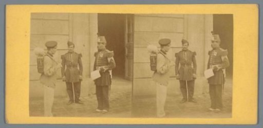 Two soldiers and a man with a knapsack before a barracks