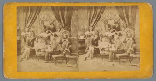 Company in a sitting room, with a man on the right looking through a picture frame