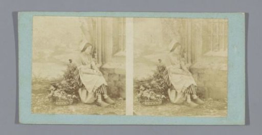 Theatrical performance of a woman with clogs and flower basket in front of a set