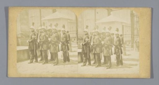 Military guard in front of a fence
