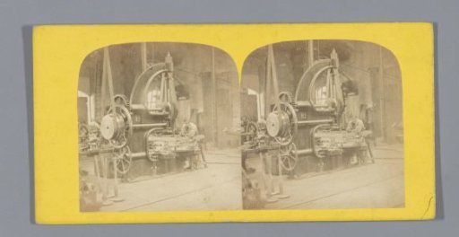 Worker at a mechanical device in a factory