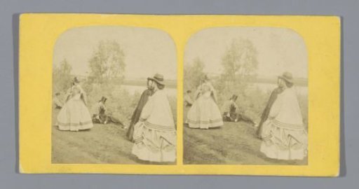 Women playing badminton and spectators on the waterfront