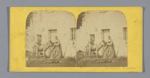 Woman with two boys and a donkey in front of a house