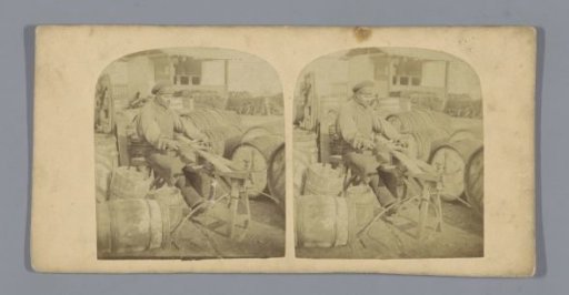 Maker of wooden barrels at work on the street