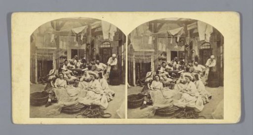 Theatrical representation of women in a tavern among ropes and nets, with men sitting in the background