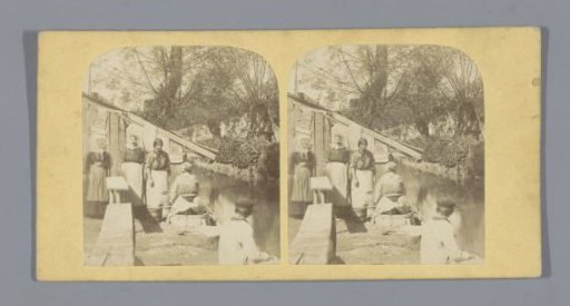 People in front of a barn by a ditch