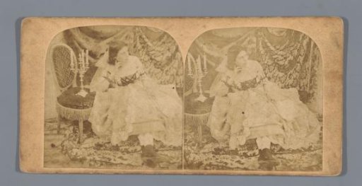 Woman sitting next to a chair with a candlestick