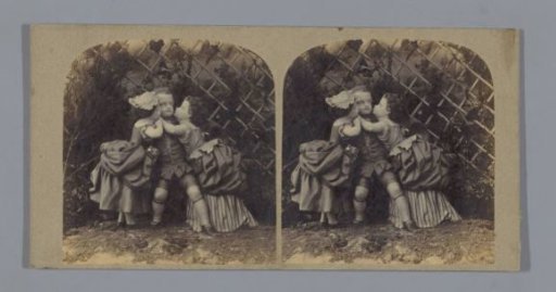 Staging with three dolls, representing a boy being kissed by two girls