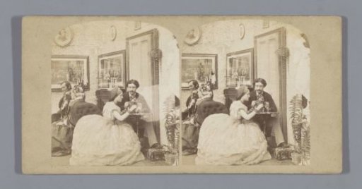 Two couples playing parlor games at a table