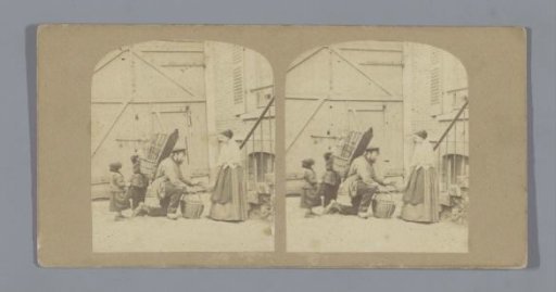Peddler and a woman in front of a house, two children rummaging in his basket