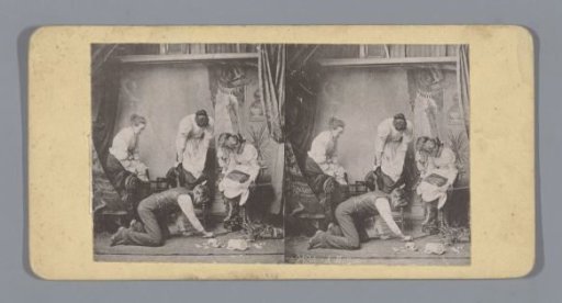 Theatrical performance of a man kneeling looking at a mouse and four women sitting with their skirts raised
