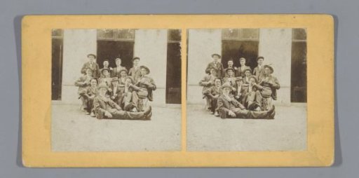 Portrait of a group of unknown boys in front of a building