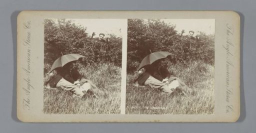 Couple outside under an umbrella with a man in the background
