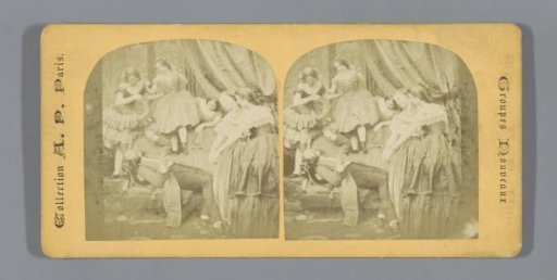 Man lying on a sofa in a salon, surrounded by young women