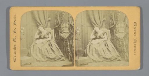 Sleeping woman in a chair with a book on her lap