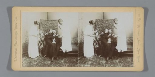 Couple receiving blessing from man dressed in nightshirt
