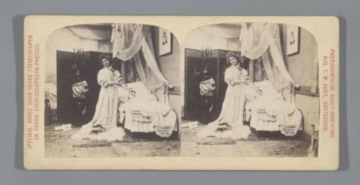 Young woman in bedroom pointing at object