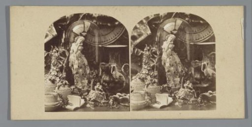 Still life with figurines, bell jar, vase and book
