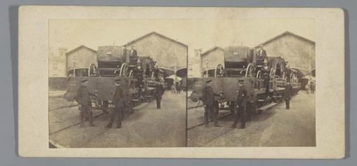 Men posing on and in front of a railway wagon with carriages