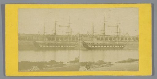 Sailing ship moored on the bank of a river in a French city