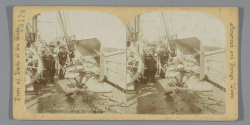 Sailors next to a machine gun on a ship