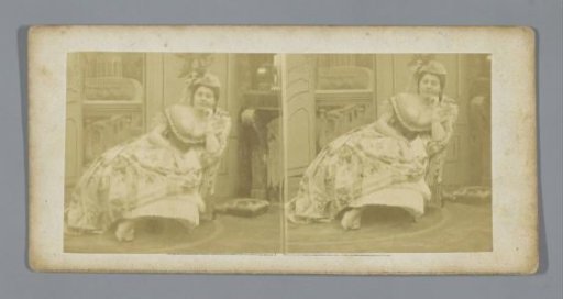 A woman posing with a book in an armchair