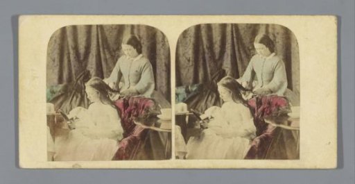 Woman combing the hair of another woman
