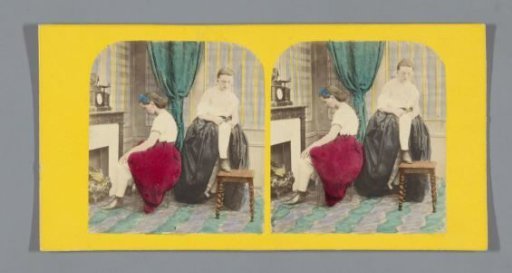 Living room scene with two women before a fireplace