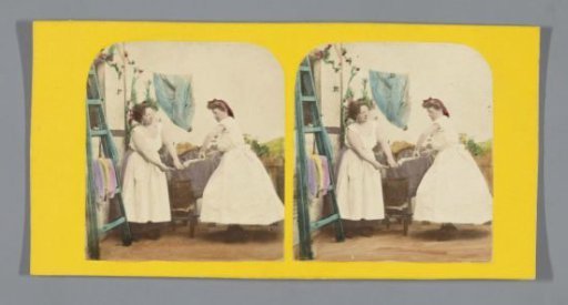 Two women wringing laundry together