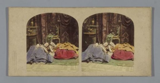 Two women sleeping on a rug on the floor