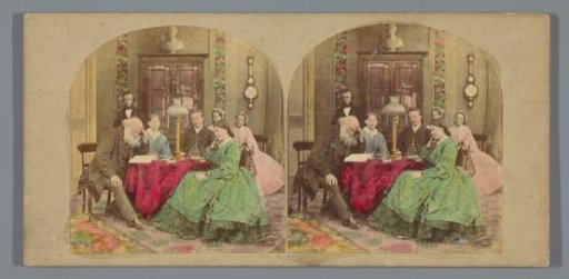 Family at table during evening prayer