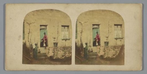 Man with a dead hare in front of a house