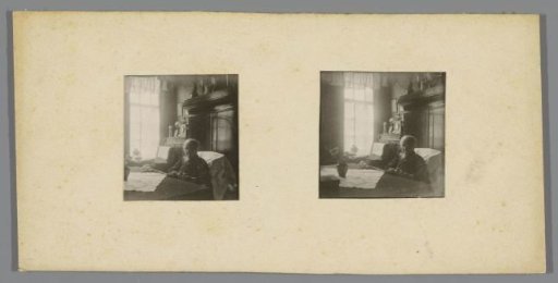 Portrait of an unknown old woman with newspaper at a table