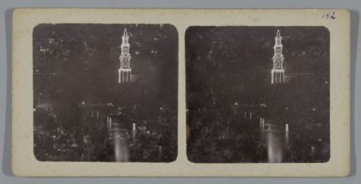 Illuminated tower of the Westerkerk reflected in the Prinsengracht, Amsterdam