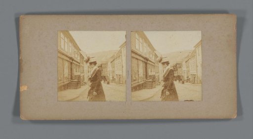 Woman with a child in a side street of the Strandgaten in Bergen, Norway