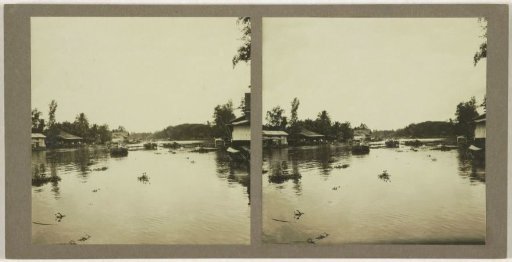 View of a river with several ships, presumably the Sungai Negara in Borneo, Indonesia
