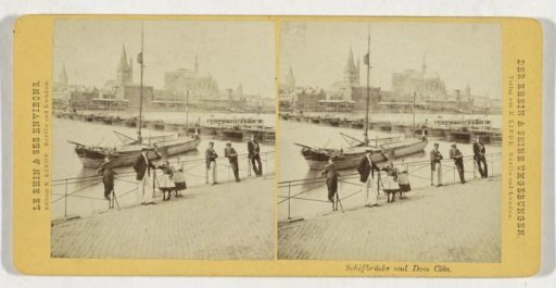 People on the quay in Cologne, with a ship bridge and the cathedral in the background